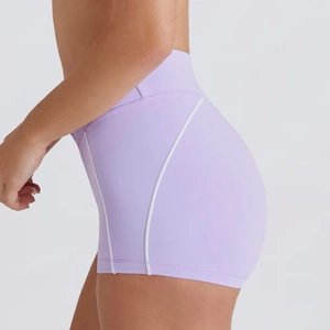 Detail showing high-waisted lavender yoga shorts with white contrast stitching for fitness