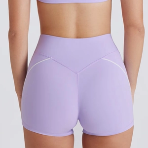 Detail view of high-waisted lilac yoga shorts with white contrast stitching for butt lift