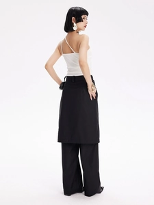 Détail d'un haut caraco blanc associé à un pantalon noir superposé pour le fitness