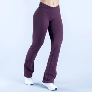 Detail of high waisted V-cross waist design and flared hem on purple yoga pants