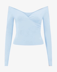 Close-up of light blue off-shoulder yoga top with crossover neckline and built-in pads