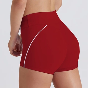 Close-up of red high-waisted fitness shorts with white side stripes and lifting effect