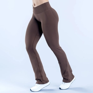 Detail of high-waisted ribbed waistband and flared leg on brown yoga pants