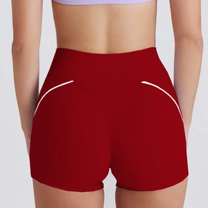 Detail of high-waist dark red fitness shorts with white contrast trim for glute shaping