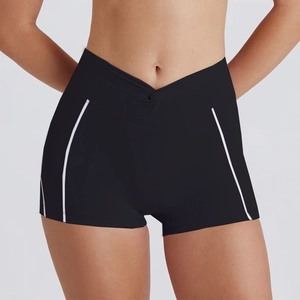Detail view of high-waist black gym shorts with crossover V-waistband and side stripes