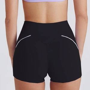 Close-up of high-waisted black yoga shorts with lavender contour lines on the back