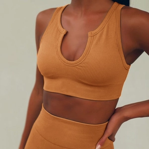 Detail of mustard yellow ribbed sports set featuring U-neck bra and high-waist shorts