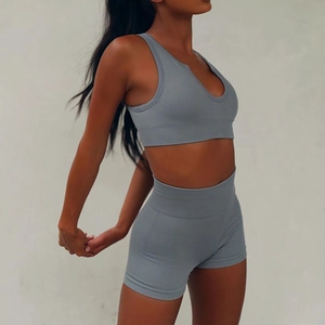 Detail of ribbed gray-blue yoga set featuring a V-neck tank top and high-waist shorts