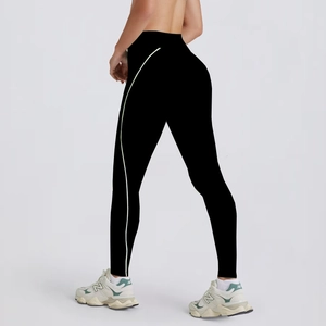 Detail of high-waisted black yoga pants with curved contrast stripe and elastic fit