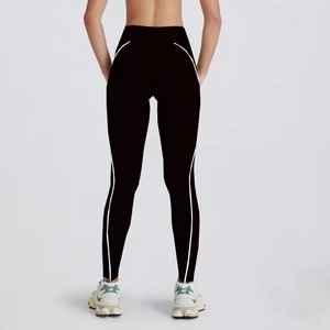 Detail view of black high-waisted yoga leggings with white curved lines for butt lifting