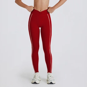 Detail of high-waisted V-cut yoga leggings in dark red with white side stripes decoration