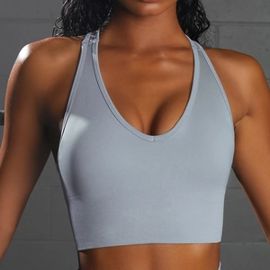 Close-up of seamless light blue-gray sports bra with deep V-neck and ribbed texture
