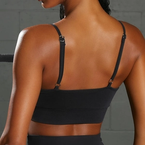 Close-up of adjustable spaghetti straps and ribbed texture on back of black sports bra
