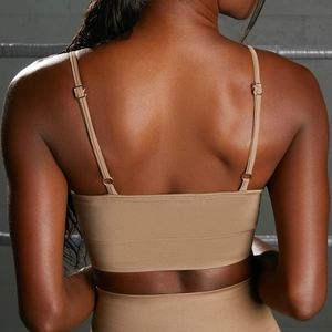Detail of seamless ribbed yoga set featuring adjustable thin straps and wide support band