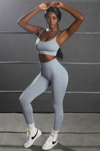 Close-up of seamless light blue yoga set with high-waisted leggings and strappy sports bra