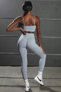 Close-up of light blue seamless yoga set with ribbed waistband and strappy sports bra