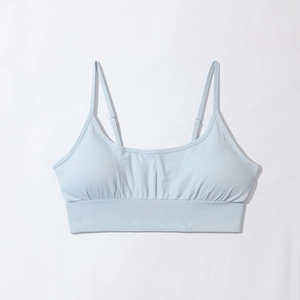 Detail of light blue sports bra with adjustable spaghetti straps and ribbed wide hem
