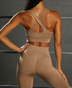 Detail of cross-back yoga bra and high-waisted scrunch butt leggings in earthy brown tones