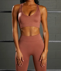 Detail of seamless high-waist yoga leggings and racerback bra in ribbed stretch fabric
