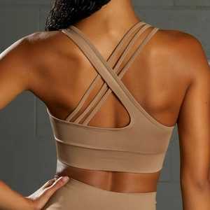 Detail of coffee brown seamless yoga set featuring multi-strap crisscross back design