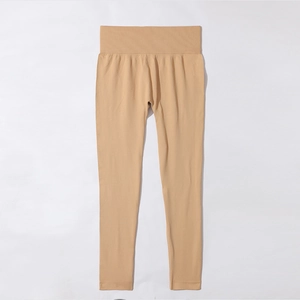 Detail of high-waist seamless apricot yoga leggings with wide tummy control waistband