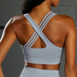 Detail of cross-back straps and ribbed hem on light blue seamless sports bra