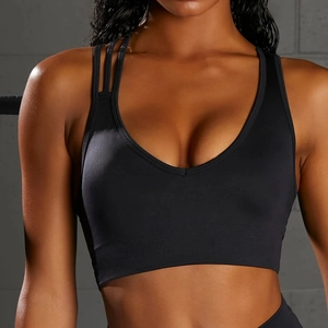 Detail of black sports bra featuring asymmetric double straps and wide ribbed hem