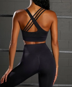 Detail of cross-back yoga bra straps and ribbed waistband on seamless black gym set