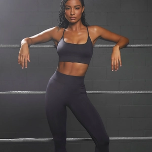 Women's two-piece charcoal grey yoga set with sports bra and high-waisted leggings