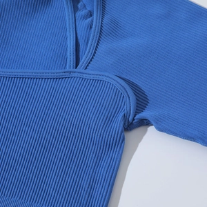 Macro shot of blue ribbed knit texture and seam craftsmanship on seamless yoga wear