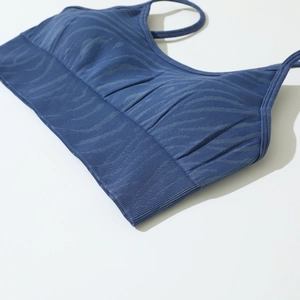 Detail of dark blue seamless sports bra with wavy texture and ribbed wide band