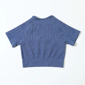 Close-up of greyish-blue seamless workout crop top with zebra-style jacquard texture