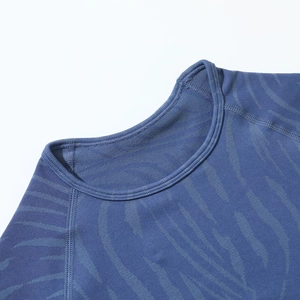 Detail of dark blue seamless yoga top featuring raglan sleeves and ribbed texture