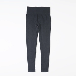Detail view of seamless high-waist yoga leggings in black with elastic compression fabric