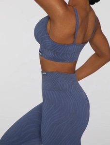 Close-up of seamless animal pattern knit yoga set with Bo+Tee brand label detail