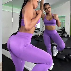 Mirror view showing seamless purple yoga set with high waist leggings and sports bra