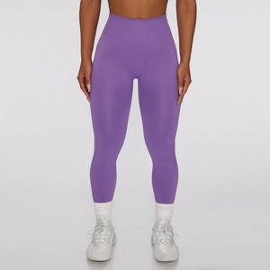 Close-up of purple high-waisted seamless knit yoga pants with tummy control compression