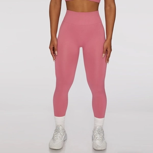 Detailed close-up of pink high-waisted seamless yoga leggings with ribbed waistband