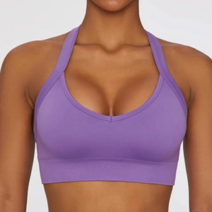 Detail of purple halter sports bra with deep V-neck and supportive elastic waistband
