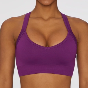 Close-up of deep purple seamless sports bra with wide elastic hem and U-neckline detail