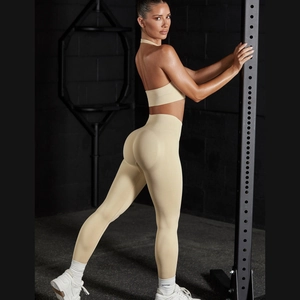 Close-up of beige seamless yoga set featuring a backless halter bra and scrunch butt shorts