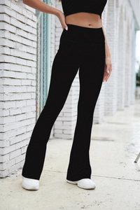 Detail of high waisted ribbed flare leggings with elastic fabric for yoga and fitness