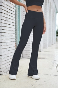 Detail of grey ribbed flared leggings showing high waist texture and slim fit design