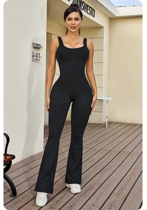 Close-up of black sleeveless flared jumpsuit showing stretchy fabric and slimming silhouette