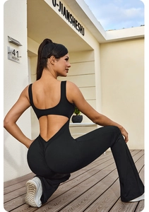 Detail of black backless yoga catsuit with cutout design and flared leg silhouette
