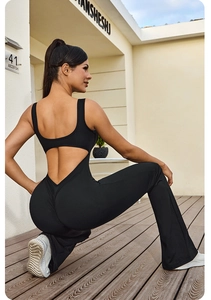Close-up of black backless yoga jumpsuit with flared pants and high-stretch fabric