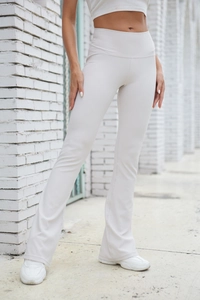Close-up of beige ribbed flare leggings showing elastic high waist and textured fabric