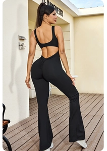 Black backless yoga jumpsuit featuring scrunch butt detail and flared leg design