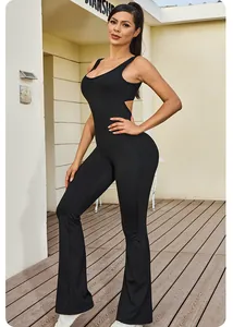 Sleeveless open back black yoga jumpsuit with flared pants and waist cut-out detail