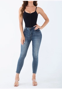 Detailed full-body shot of high-waist jeans paired with a zipper compression bodysuit